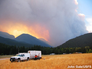 A distant mountain illuminated by the fire's glow.