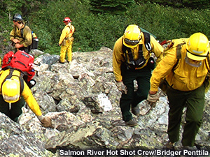 Crew scrambles up the scree slope.